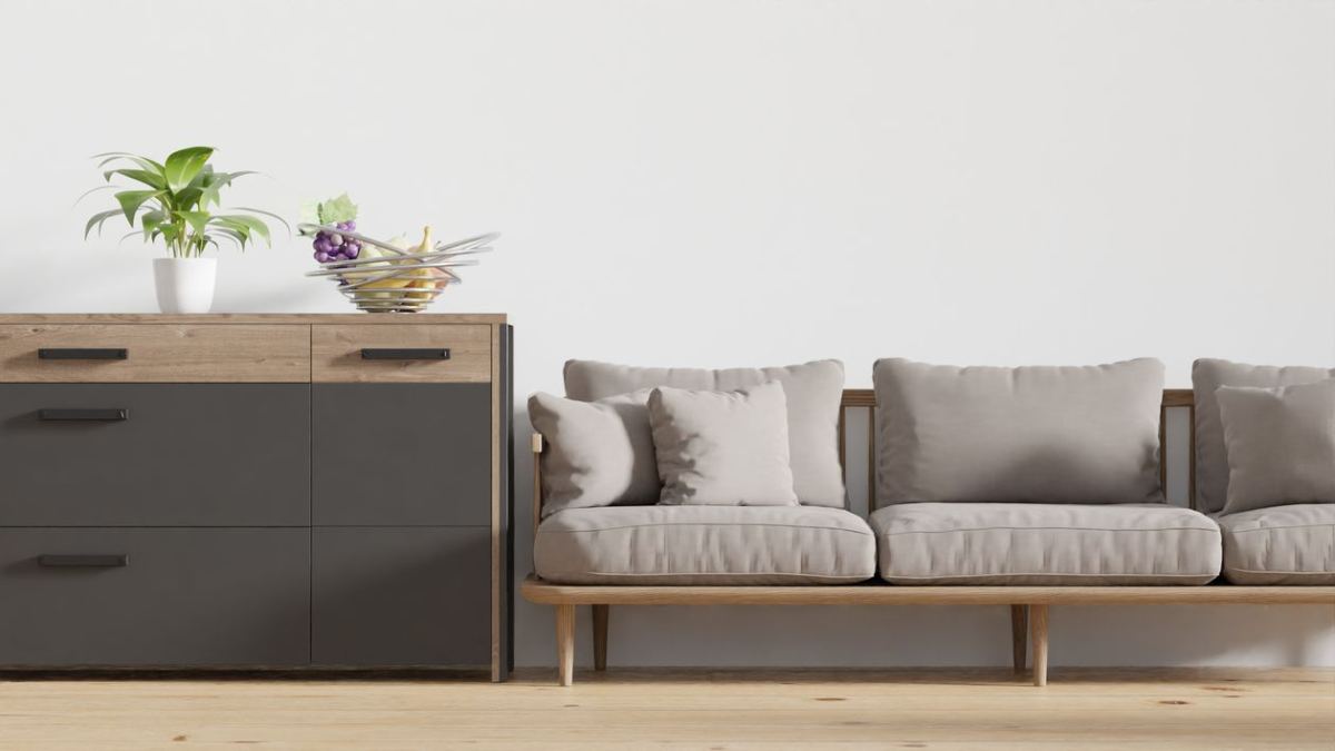Commode en bois dans un salon près d'un canapé beige